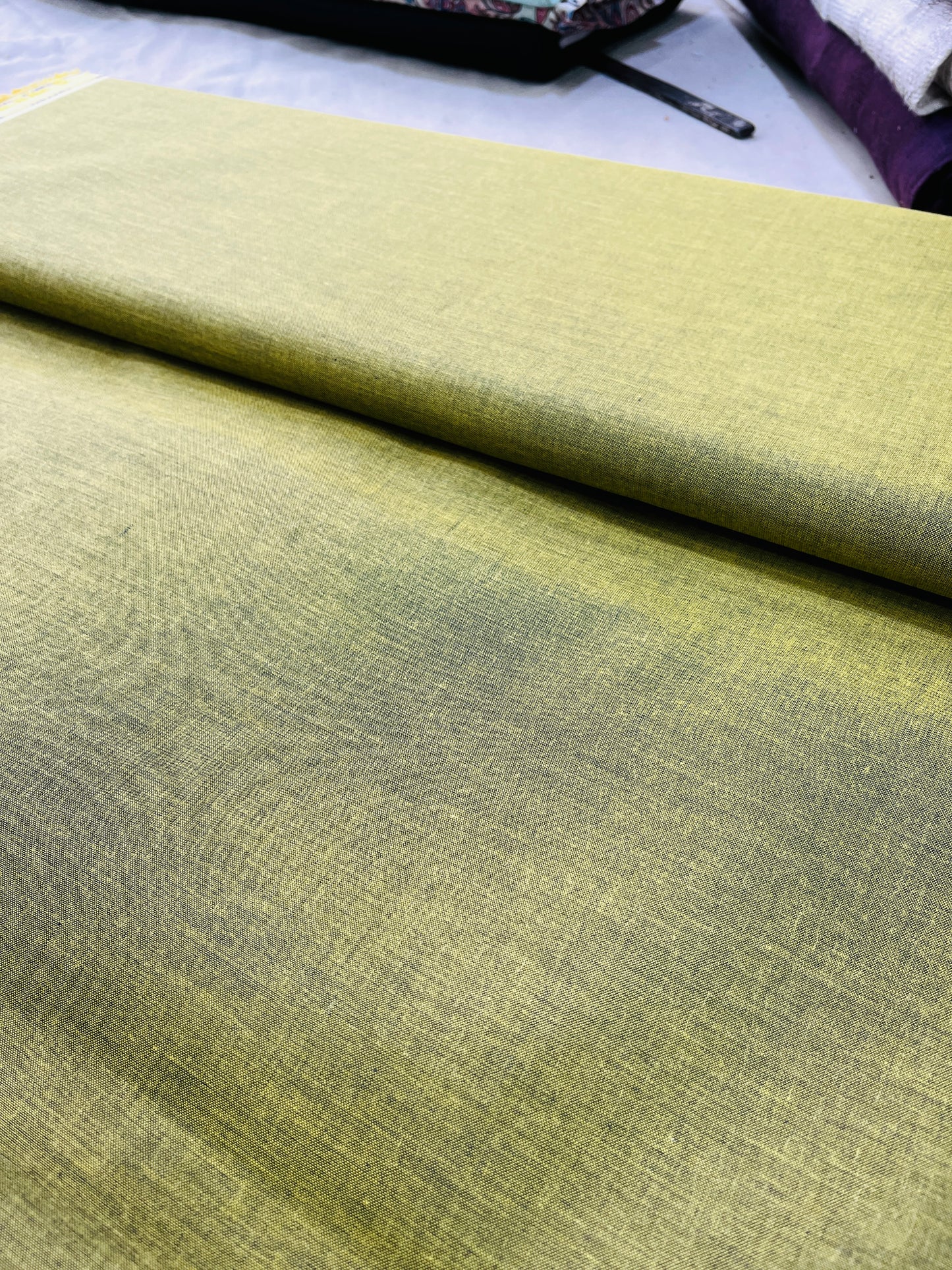 Mustard fabric with a slight texture on a plain background