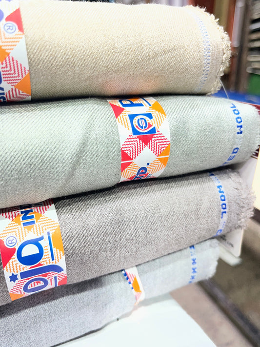 Stack of fabric rolls with colorful labels on a blurred background