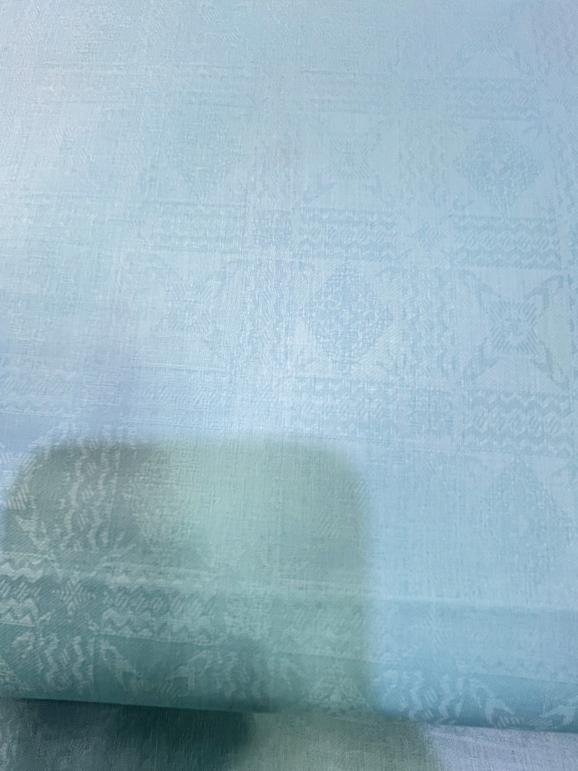Close-up of textured light blue fabric addi.