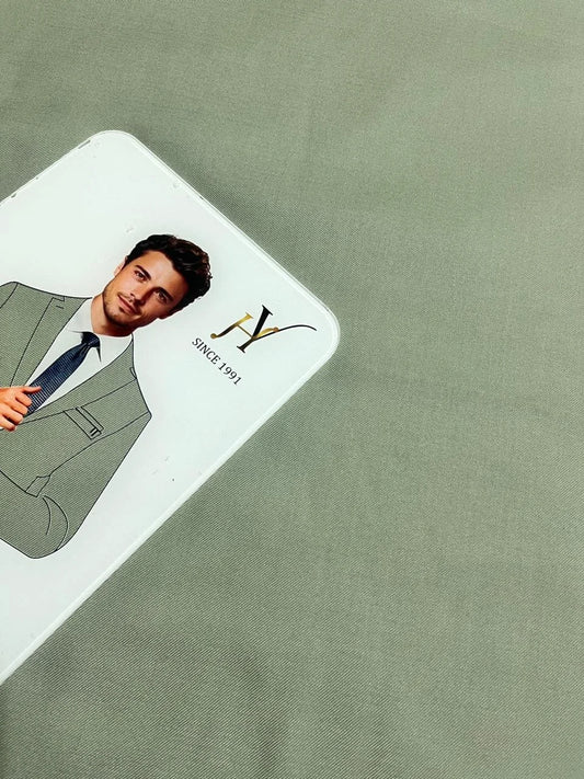 Card with a man in a suit and tie on a green fabric background