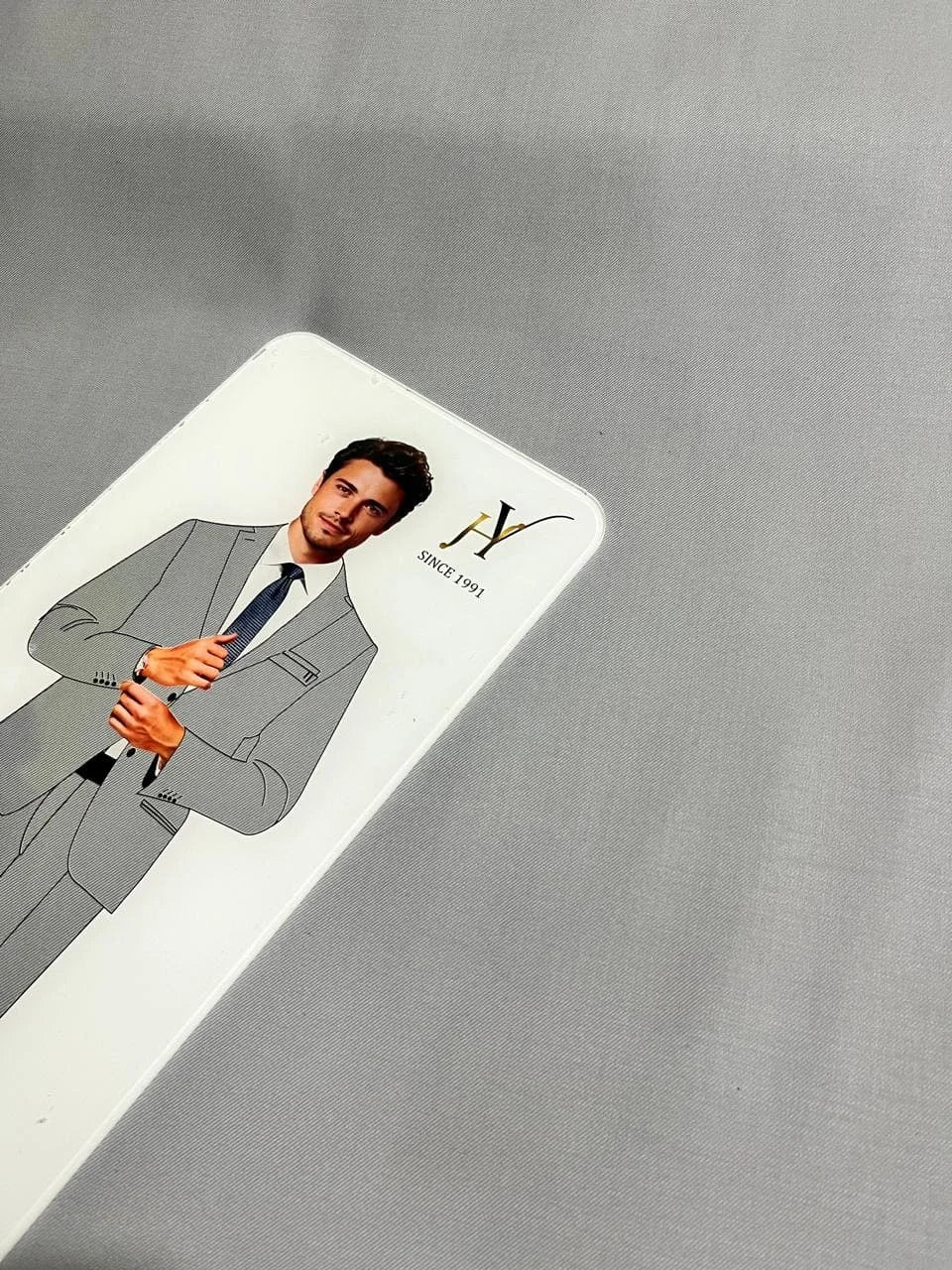 Card with a person in a suit on a gray fabrics