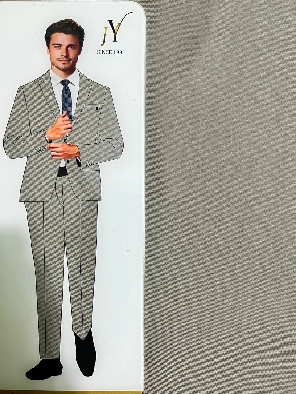 Gray suit with a model and brand logo on a gray background
