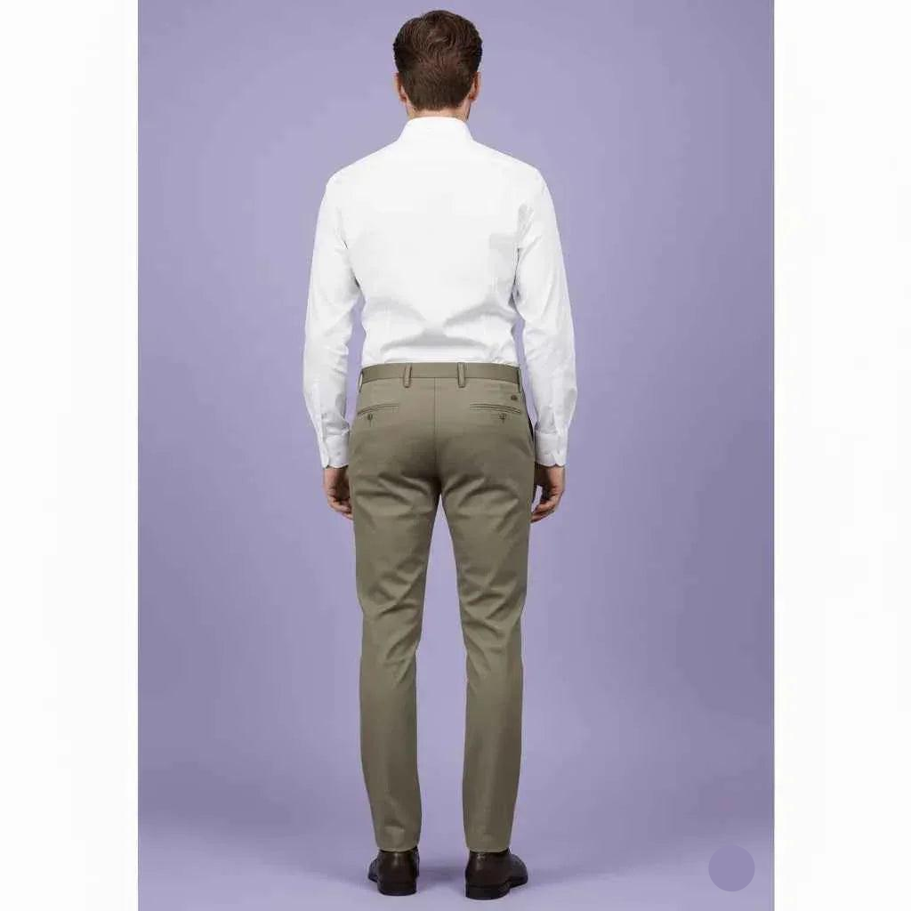 Man wearing a white shirt and green pants on a light purple background